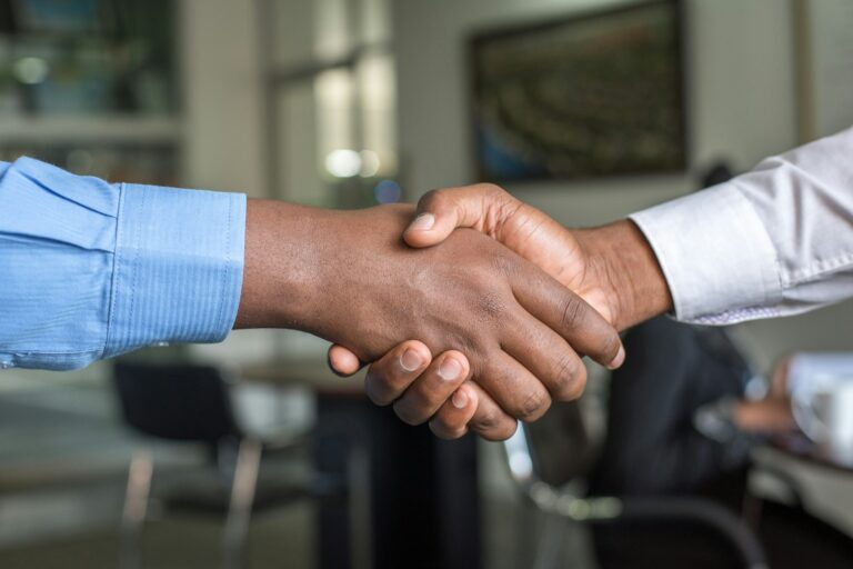 Physician and advisor shaking hands to buy a medical practice
