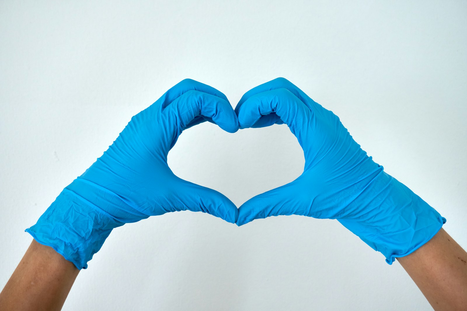 OSHA compliance for medical practices — clinician wearing protective nitrile gloves (PPE)