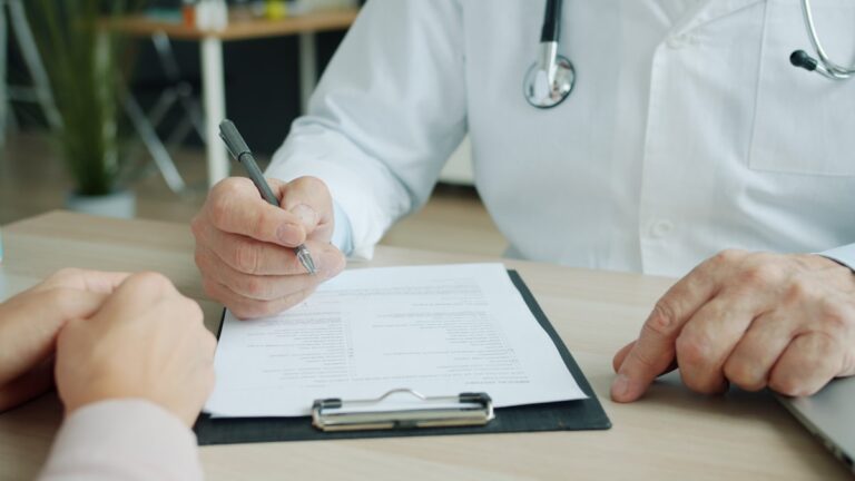 Doctor reviewing a patient chart, illustrating patient retention strategies in a medical practice