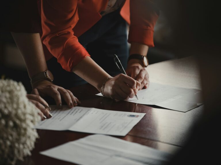 Physician and advisor signing an agreement to sell a medical practice