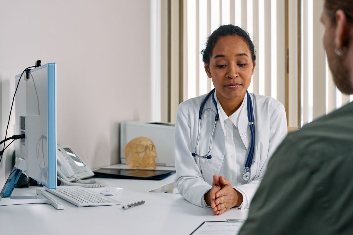Physician discussing a direct primary care membership with a patient in a medical office
