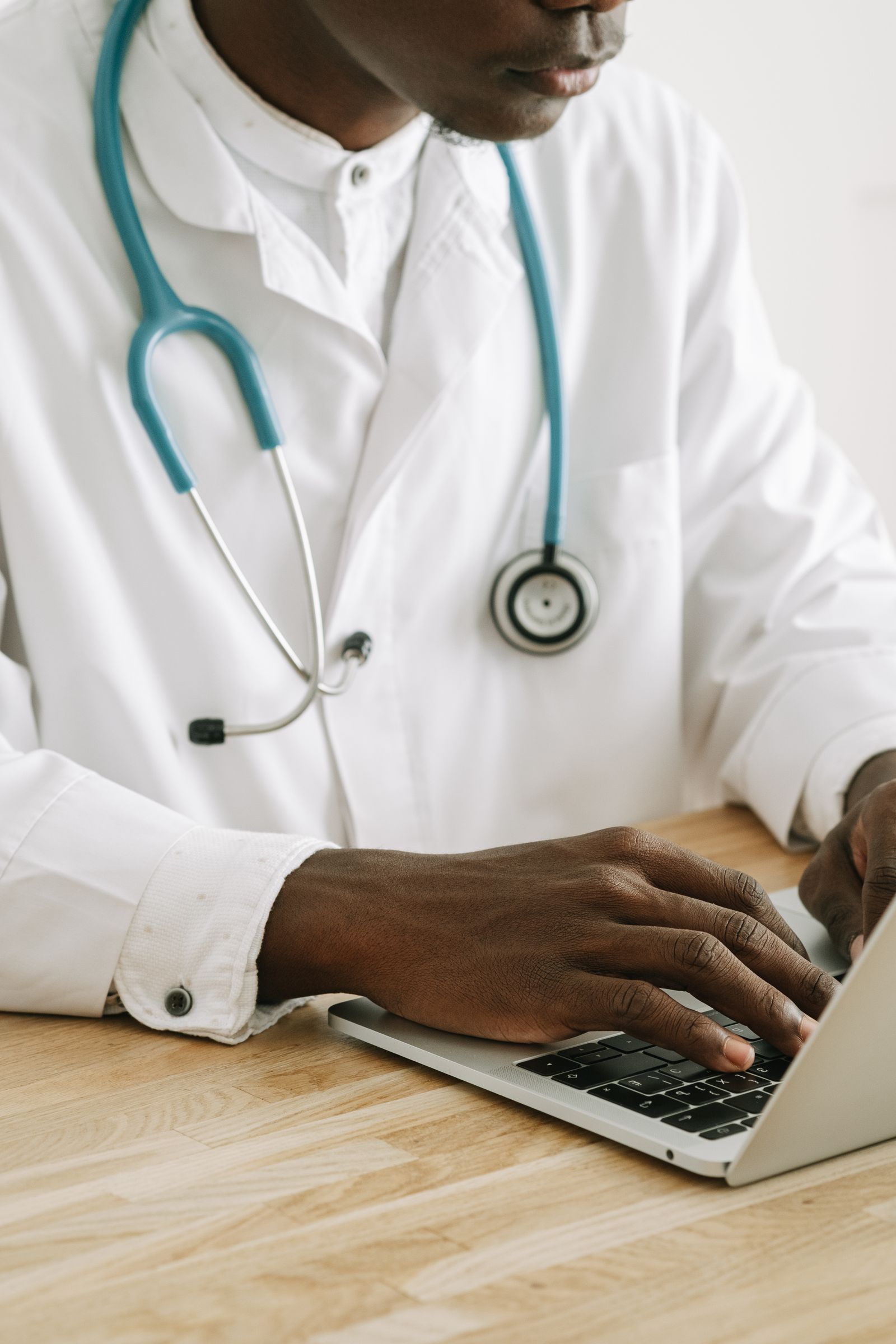 Physician using an EHR system for a medical practice on a laptop