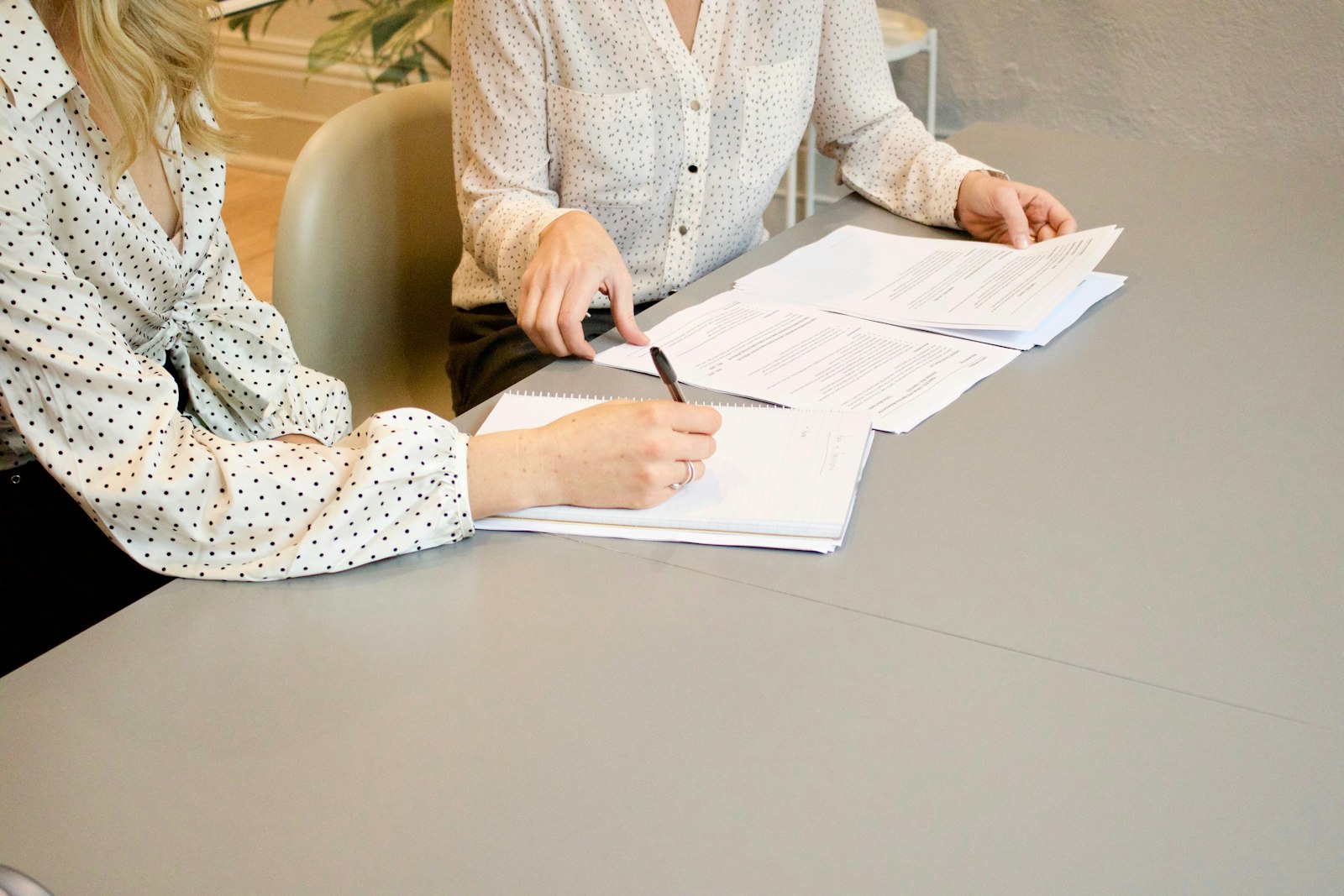 Physician and advisor reviewing a medical office lease agreement before signing at a medical practice