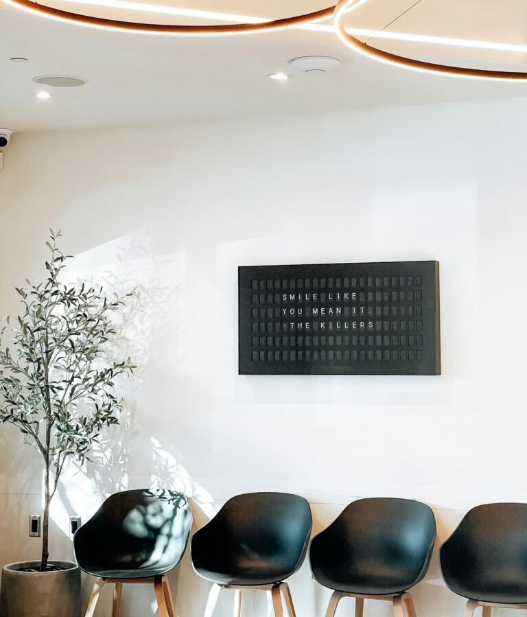Patients seated in a medical office waiting room, illustrating patient wait times at a medical practice