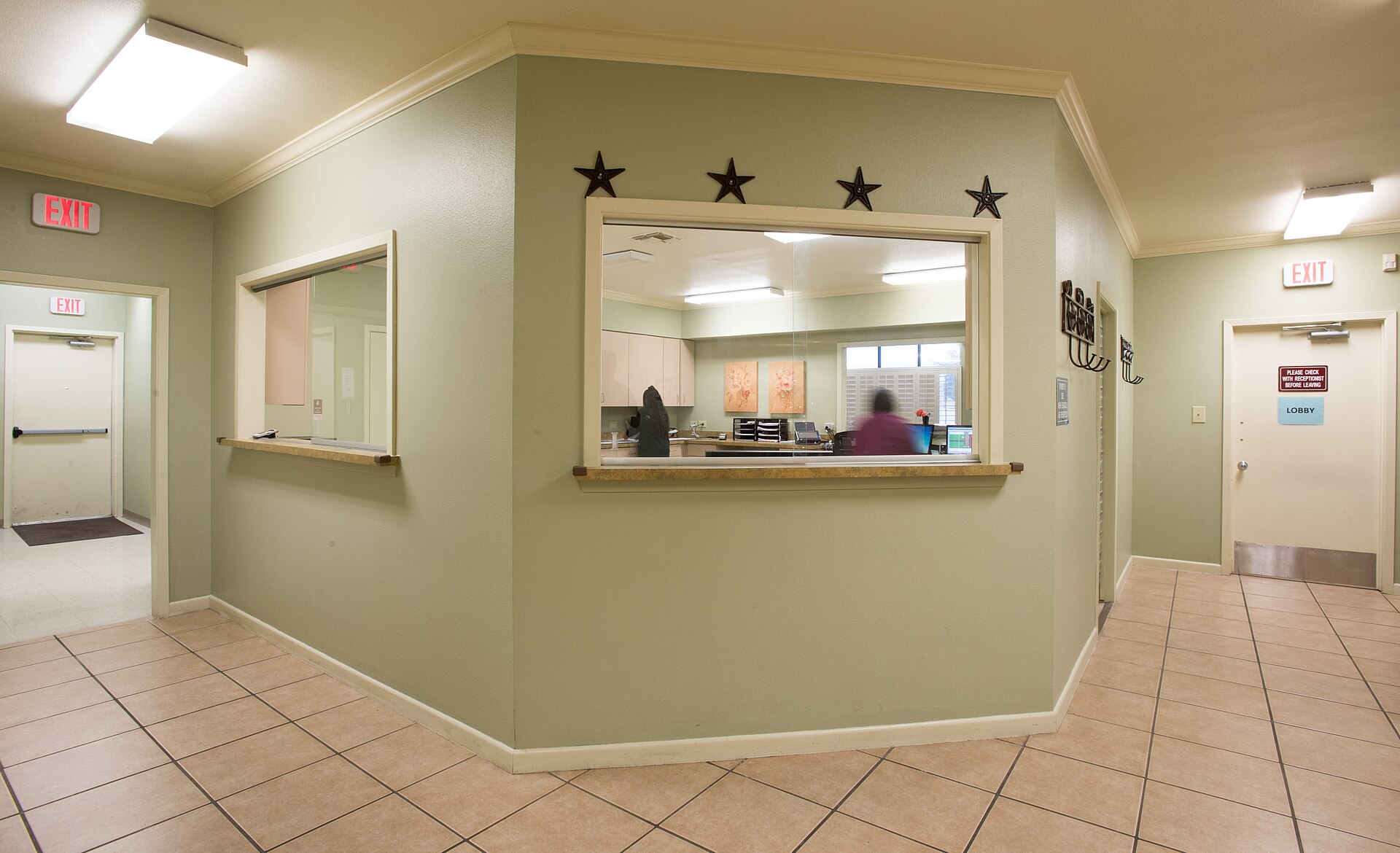 Medical practice front office window where staff perform insurance eligibility verification before patient visits